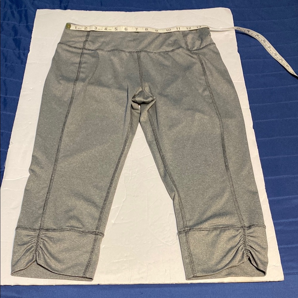 Danskin Now size M 8-10, gray capri leggings with ruched seam on side at bottom.